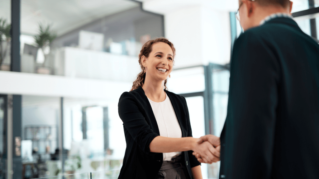 A woman shakes hands and makes a great first impression