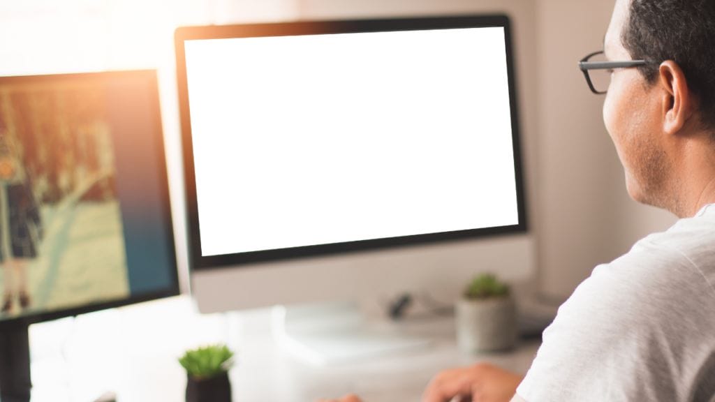 A man types at his computer, ready to target his LinkedIn Profile