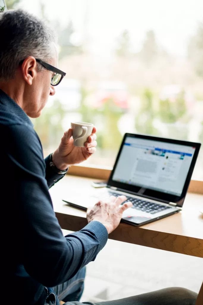 Executive looking at LinkedIn on a laptop